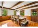 Well-lit dining room with wood floors, beamed ceilings, large windows, and seating for eight at 258 Lancaster Cir, Marietta, GA 30066