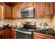 Kitchen with stainless steel appliances, granite counters, wood cabinets and breakfast bar at 258 Lancaster Cir, Marietta, GA 30066