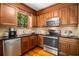 Kitchen with stainless steel appliances, granite counters, wood cabinets, and a window view at 258 Lancaster Cir, Marietta, GA 30066