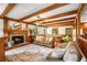 Spacious living room with exposed beams, a brick fireplace, and hardwood floors at 258 Lancaster Cir, Marietta, GA 30066