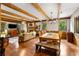 Open-concept living space with wood floors, dining area, exposed beams, and a cozy seating area at 258 Lancaster Cir, Marietta, GA 30066