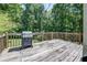 Wooden back deck with a grill and wooded views at 2903 Southpark Sw Ter, Conyers, GA 30094