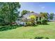 Beautiful backyard featuring a deck, lush greenery, and mature trees at 2903 Southpark Sw Ter, Conyers, GA 30094