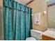 Bathroom showcasing a shower, toilet, and decorative green curtain at 2903 Southpark Sw Ter, Conyers, GA 30094