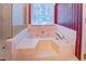 Corner soaking tub with jets and a view from the window at 2903 Southpark Sw Ter, Conyers, GA 30094