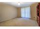 Bedroom with neutral walls, tan carpet and ceiling fan with light at 2903 Southpark Sw Ter, Conyers, GA 30094