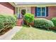 Charming front porch with brick steps leading up to the front door, surrounded by green bushes at 2903 Southpark Sw Ter, Conyers, GA 30094