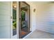 Close-up view of the front porch with sliding glass door and white siding at 2903 Southpark Sw Ter, Conyers, GA 30094