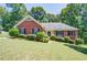 Beautiful brick home with a well-manicured lawn and lush landscaping, enhancing its curb appeal at 2903 Southpark Sw Ter, Conyers, GA 30094