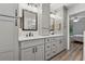 Bathroom featuring double sinks, quartz countertops, and gray cabinets at 76 Hollis Cir, Dallas, GA 30157
