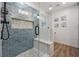 Bathroom features a walk-in shower with blue subway tile and a built-in bench at 76 Hollis Cir, Dallas, GA 30157
