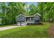 Charming two-story home features a covered porch, two-car garage, and lovely landscaped front yard at 76 Hollis Cir, Dallas, GA 30157