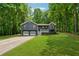 Charming two-story home features a covered porch, two-car garage, and lovely landscaped front yard at 76 Hollis Cir, Dallas, GA 30157