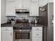 Well-equipped kitchen features stainless steel appliances, ample cabinetry, and black countertops at 76 Hollis Cir, Dallas, GA 30157