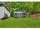 Exterior of the backyard shed with double doors and windows; perfect for storage or as a hobby space at 76 Hollis Cir, Dallas, GA 30157