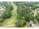 Aerial view of the home surrounded by mature trees near a golf course at 105 Thorncliff Way, Acworth, GA 30101