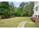 Large backyard features a wooded area with walking trail at 105 Thorncliff Way, Acworth, GA 30101