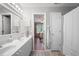 Bright bathroom features double sinks, white cabinets, and wood look flooring at 105 Thorncliff Way, Acworth, GA 30101