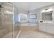 Bathroom featuring tiled floors, a shower with glass doors, and a soaking tub at 105 Thorncliff Way, Acworth, GA 30101