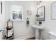 Charming bathroom features shiplap walls, a pedestal sink, and decorative accents at 105 Thorncliff Way, Acworth, GA 30101