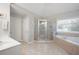 Bathroom featuring tiled floors, a shower with glass doors, and a soaking tub at 105 Thorncliff Way, Acworth, GA 30101