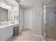 Bathroom featuring tiled floors, vanity, and a shower with glass doors at 105 Thorncliff Way, Acworth, GA 30101