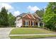 Attractive brick and siding home with a well-kept lawn, black shutters, and an extended driveway at 105 Thorncliff Way, Acworth, GA 30101
