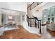 Stunning foyer featuring hardwood floors, elegant staircase, and open access to living spaces at 105 Thorncliff Way, Acworth, GA 30101