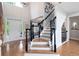 Elegant foyer with hardwood floors, a staircase, and a front door with sidelights at 105 Thorncliff Way, Acworth, GA 30101