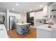Modern kitchen with stainless appliances, marble countertops, center island, and white subway tile for a sleek, clean aesthetic at 105 Thorncliff Way, Acworth, GA 30101