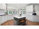 Bright kitchen features white cabinets, subway tile backsplash, island with seating, and stainless steel appliances at 105 Thorncliff Way, Acworth, GA 30101