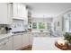 Bright kitchen features white cabinets, subway tile backsplash, and stainless steel appliances at 105 Thorncliff Way, Acworth, GA 30101