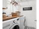 Bright laundry room with a butcher block countertop, washer, and dryer at 105 Thorncliff Way, Acworth, GA 30101