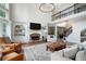 Spacious living area with fireplace, large windows, and staircase to above, bathed in natural light and comforting hues at 105 Thorncliff Way, Acworth, GA 30101
