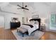 Spacious main bedroom with tray ceilings, a ceiling fan, and an ensuite bathroom at 105 Thorncliff Way, Acworth, GA 30101