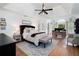 Spacious bedroom featuring a tray ceiling, a ceiling fan, a workstation, and neutral decor at 105 Thorncliff Way, Acworth, GA 30101