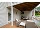 Relaxing covered patio features a ceiling fan, string lights and outdoor furniture at 105 Thorncliff Way, Acworth, GA 30101