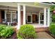 Welcoming front porch with rocking chairs, classic columns, and a view of the home's entrance at 105 Thorncliff Way, Acworth, GA 30101