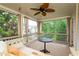 Inviting screened porch featuring a swing bed, ceiling fan, and outdoor views at 105 Thorncliff Way, Acworth, GA 30101