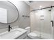 Well-lit bathroom with a sleek glass shower, a modern round mirror, and a stylish dark faucet at 170 Paislee Park (Lot #8 Paislee Park) Dr, Fayetteville, GA 30215