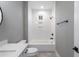 Bright bathroom with a tiled shower-over-tub with built-in shelving and a window at 170 Paislee Park (Lot #8 Paislee Park) Dr, Fayetteville, GA 30215
