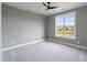 Serene bedroom featuring neutral walls, plush carpet, a ceiling fan and natural light from a window at 170 Paislee Park (Lot #8 Paislee Park) Dr, Fayetteville, GA 30215