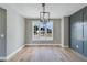 Elegant dining room with hardwood floors, decorative wainscoting, and modern light fixtures at 170 Paislee Park (Lot #8 Paislee Park) Dr, Fayetteville, GA 30215
