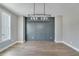 Elegant dining room with hardwood floors, paneled accent wall, modern chandelier, and natural light at 170 Paislee Park (Lot #8 Paislee Park) Dr, Fayetteville, GA 30215