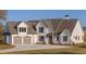 Charming two-story farmhouse with an attached two car garage and a well maintained lawn at 170 Paislee Park (Lot #8 Paislee Park) Dr, Fayetteville, GA 30215