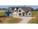 Stunning two-story farmhouse with a concrete driveway and well-manicured lawn at 170 Paislee Park (Lot #8 Paislee Park) Dr, Fayetteville, GA 30215