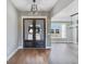 Elegant foyer featuring rich wood flooring, a chandelier, and stylish glass paneled doors at 170 Paislee Park (Lot #8 Paislee Park) Dr, Fayetteville, GA 30215