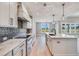 Modern kitchen boasts stainless steel appliances, marble countertops, and sleek cabinetry at 170 Paislee Park (Lot #8 Paislee Park) Dr, Fayetteville, GA 30215