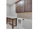 Efficient laundry area featuring dark cabinets, a folding table, and utility sink hookups at 170 Paislee Park (Lot #8 Paislee Park) Dr, Fayetteville, GA 30215