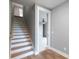 Stylish staircase with wood steps, white risers, and a light gray wall with a wooden handrail at 170 Paislee Park (Lot #8 Paislee Park) Dr, Fayetteville, GA 30215